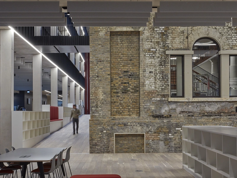 Interior shot of Tower Hamlets Town Hall with person walking down corridor.