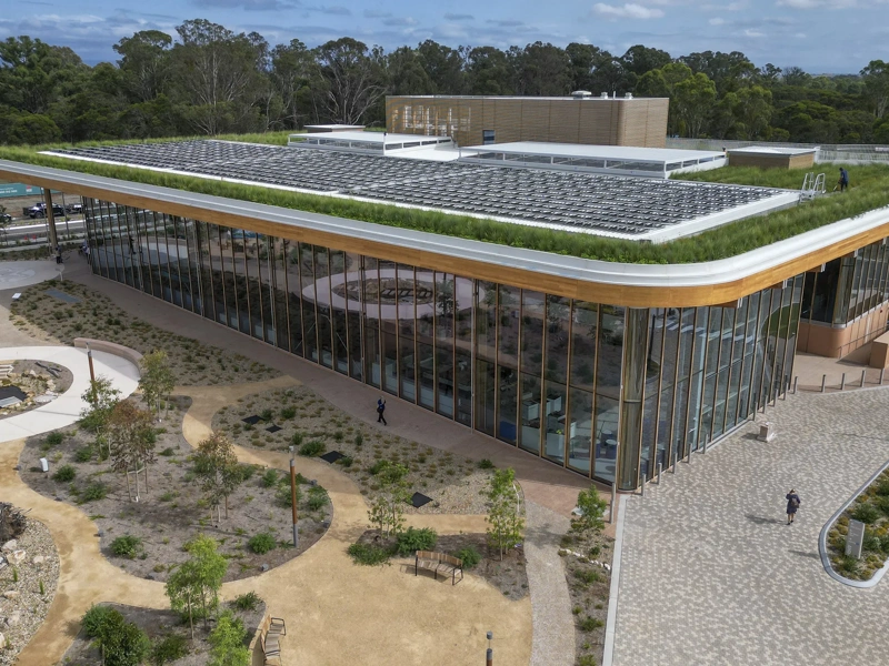 BDA first building with green grass on roof and glass windows.