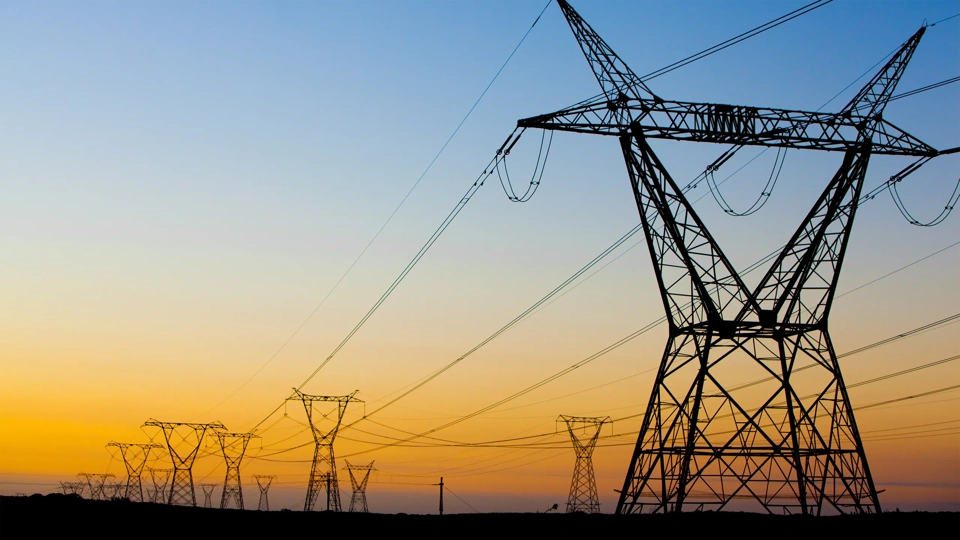 Stand under power lines in South Africa at sunset.