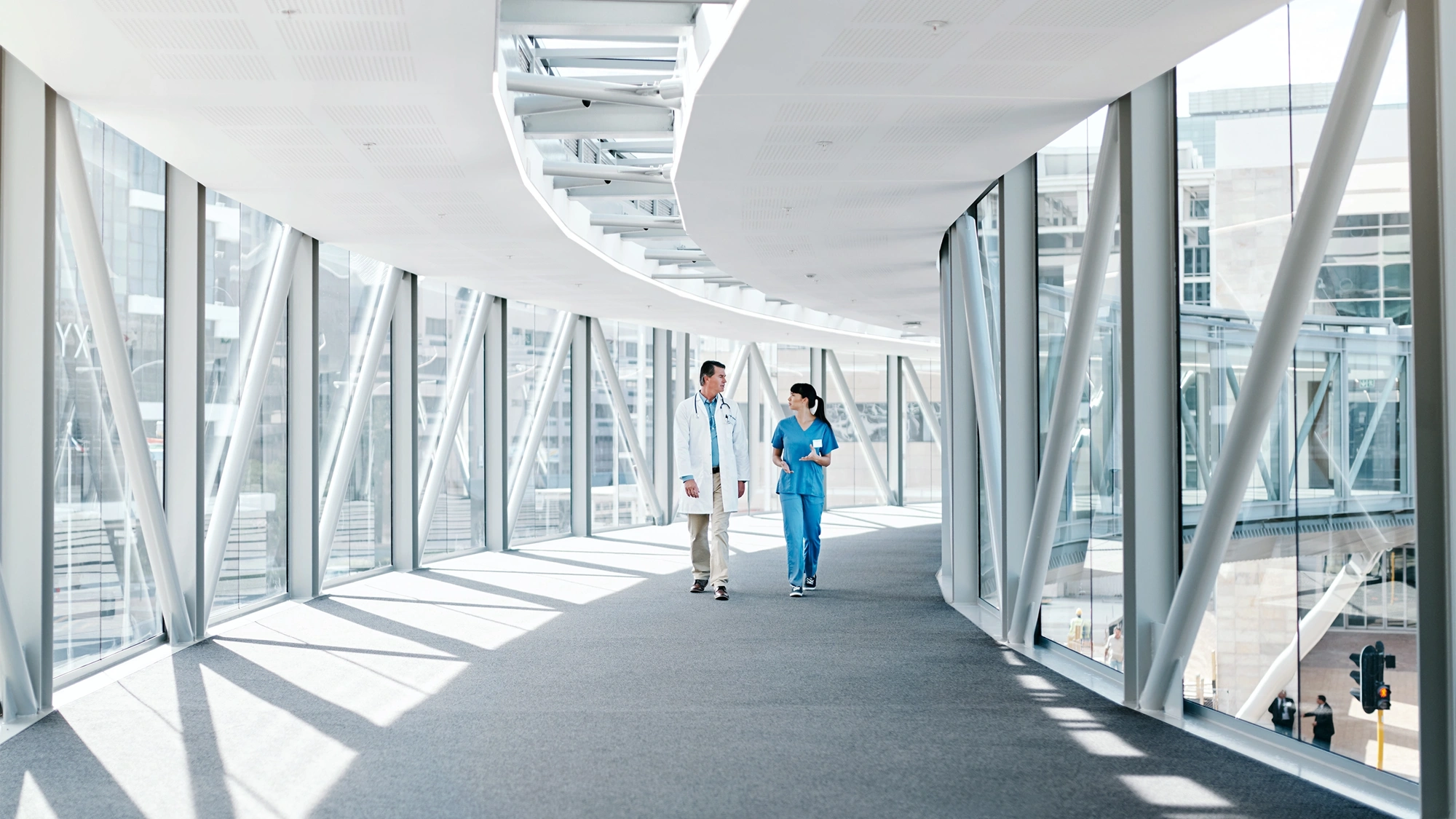 Two doctors walking down hallway.