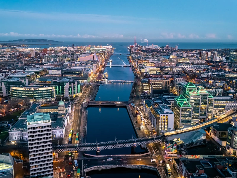Aerial view of busy city center buildings and traffic at night, Aerial view of the river Liffey and city center Dublin Ireland at night.