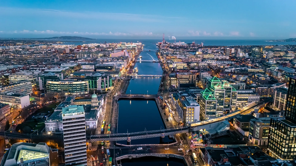 Aerial view of busy city center buildings and traffic at night, Aerial view of the river Liffey and city center Dublin Ireland at night.