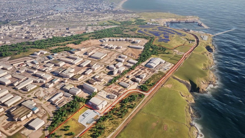 Ariel view of port with white block buildings in green field. There is also water surrounded.
