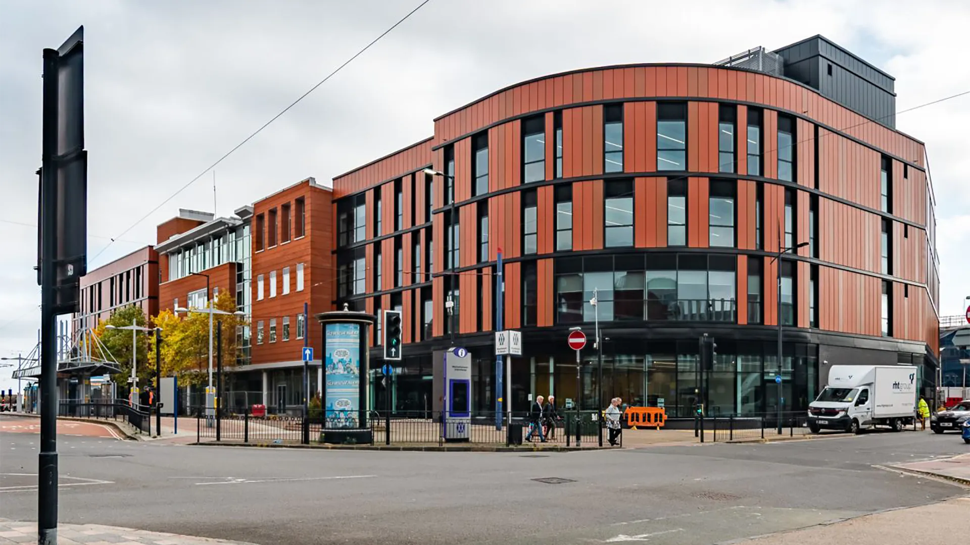 Modern multi-storey office building on city street corner.