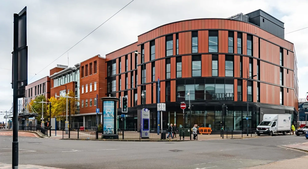 Modern multi-storey office building on city street corner.
