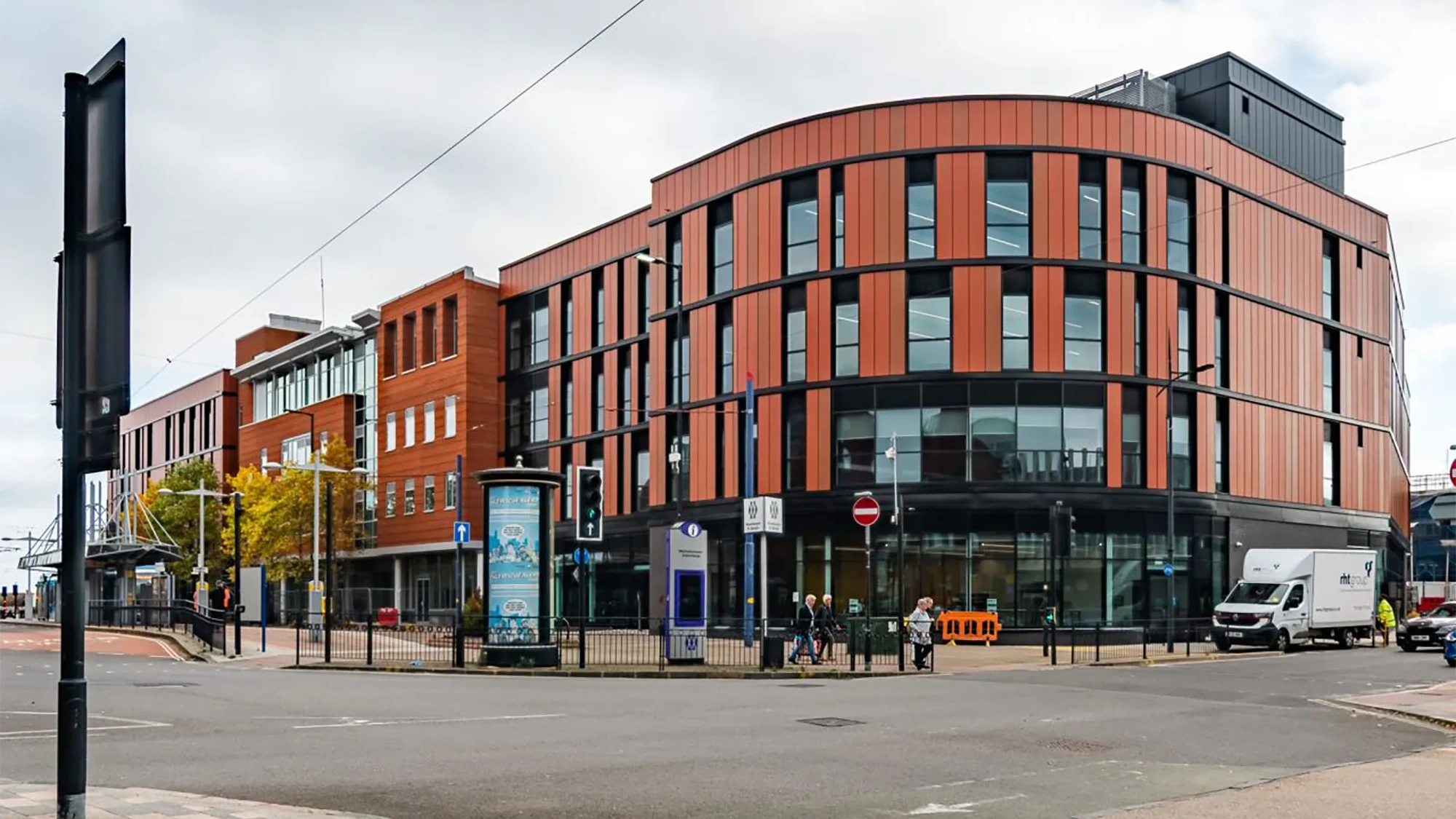 Modern multi-storey office building on city street corner.