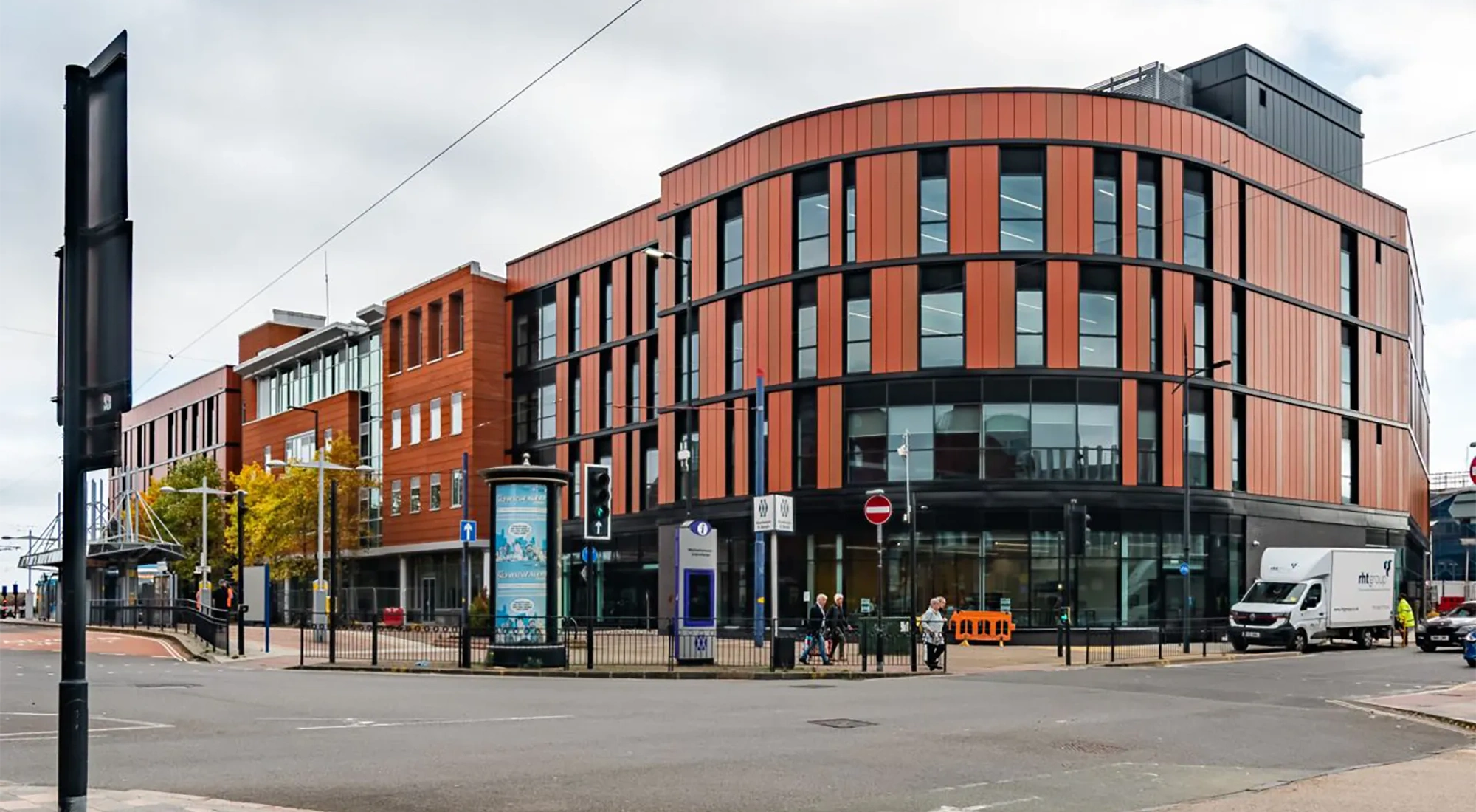 Modern multi-storey office building on city street corner.