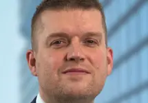 Dan Proud, Director, Infrastructure, UK, in front of a glass office building