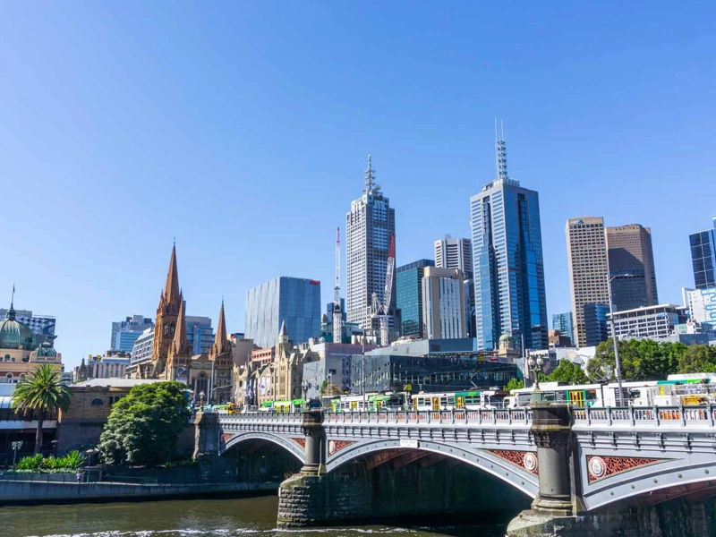 View of the city in Australia with the sky reflecting onto the buildings with a bridge showing