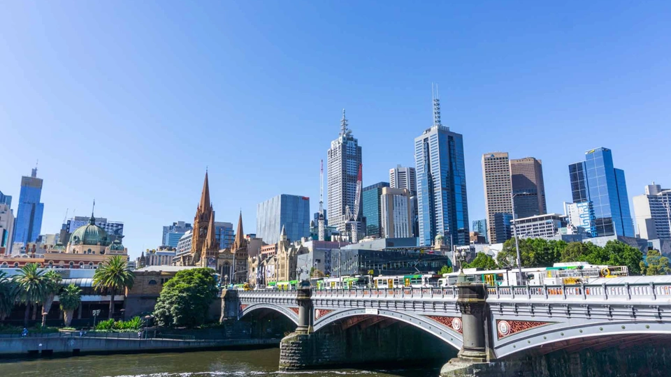 View of the city in Australia with the sky reflecting onto the buildings with a bridge showing