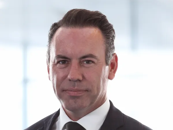 Portrait of David Smith, Director Regional Infrastructure Lead, in front of a window in office