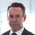 Portrait of David Smith, Director Regional Infrastructure Lead, in front of a window in office