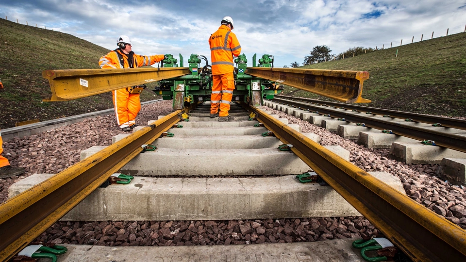 Railway workers laying track