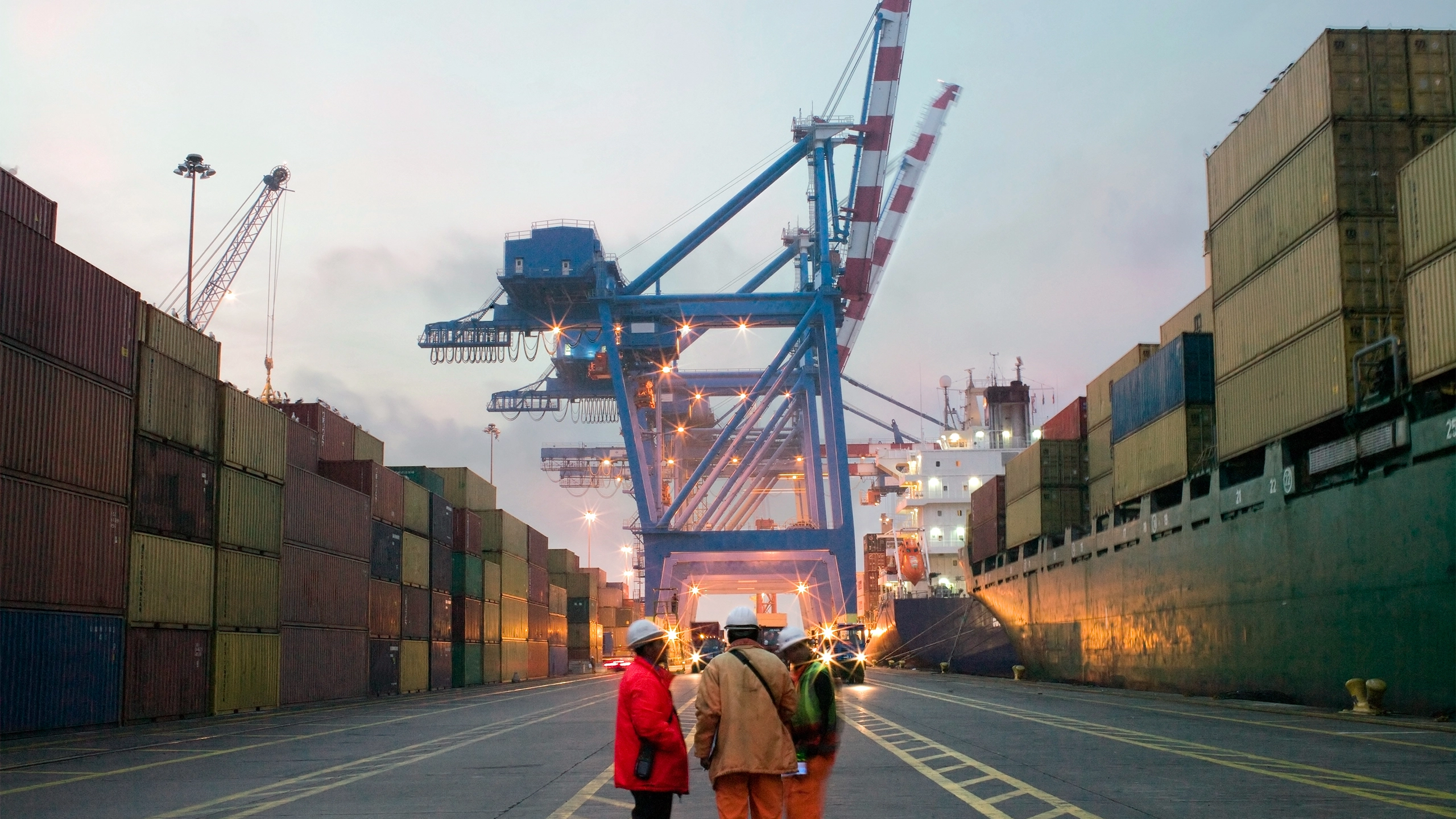 Workers talking in a shipping yard