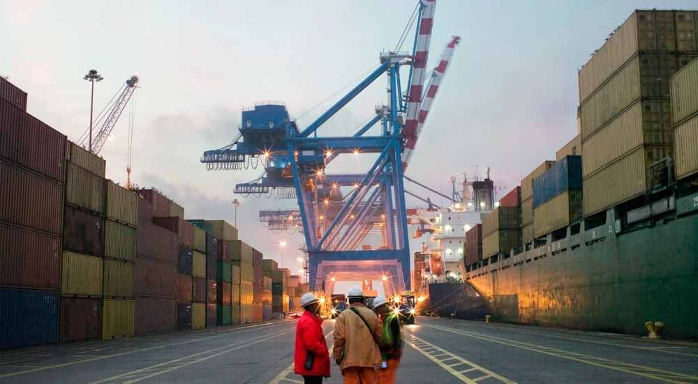 Workers talking in a shipping yard