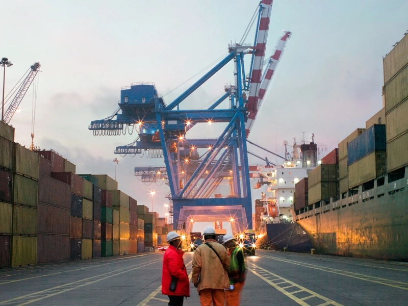 Workers talking in a shipping yard
