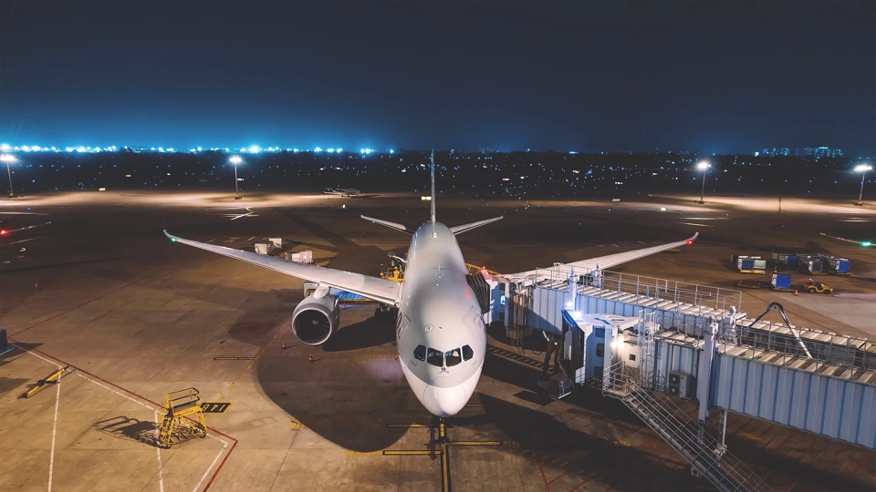 An aeroplane on a tarmac at night