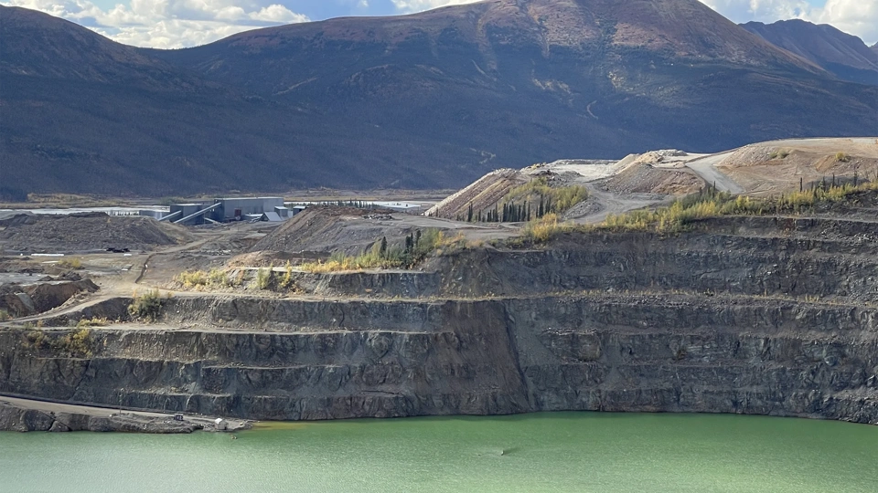 Faro Mine Remediation Project, with mountains in the back and green lake.