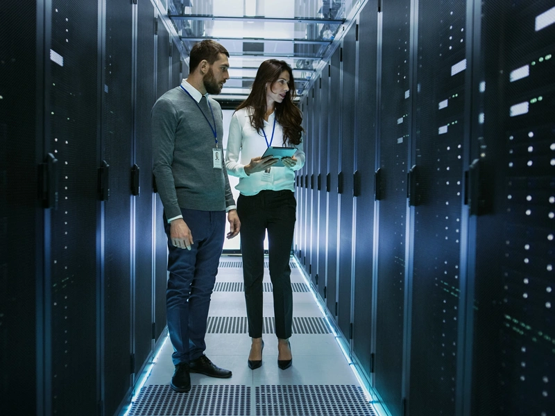Man and women in data centre office