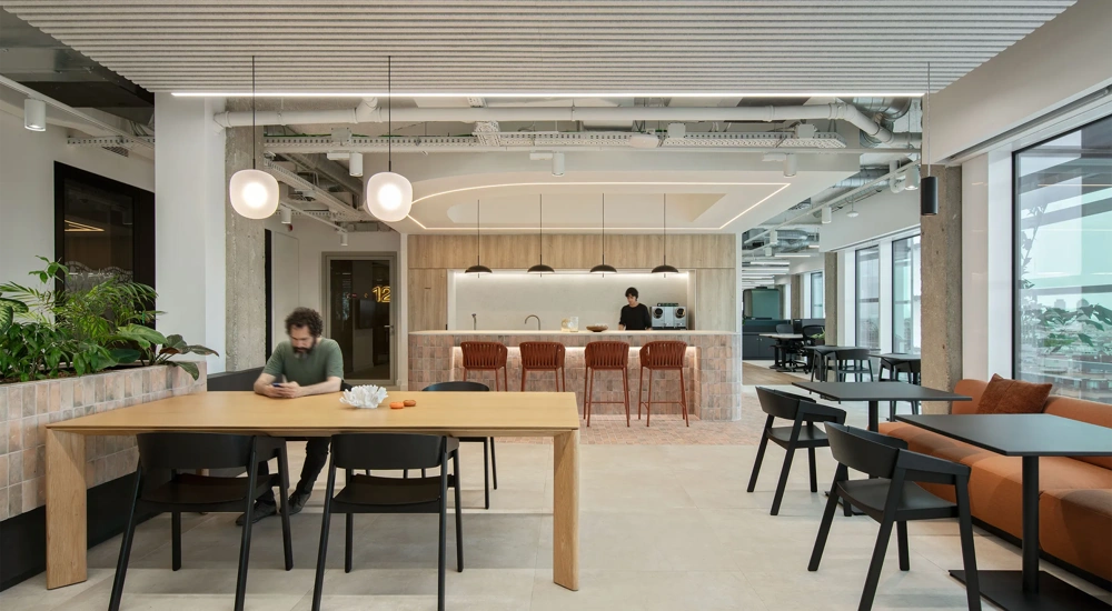 Modern office breakout area with tables, seating and a cafe style counter