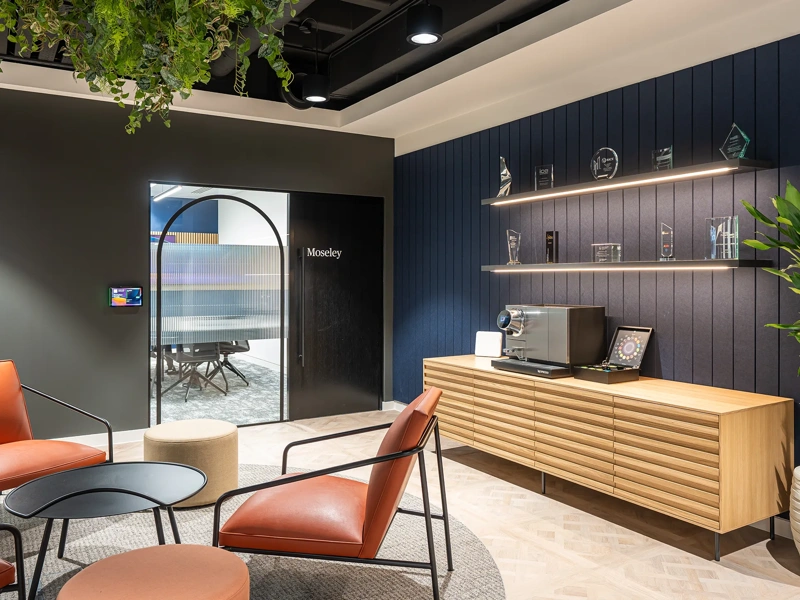 Turner & Townsend Birmingham plant based office with orange chairs and blue and grey interior