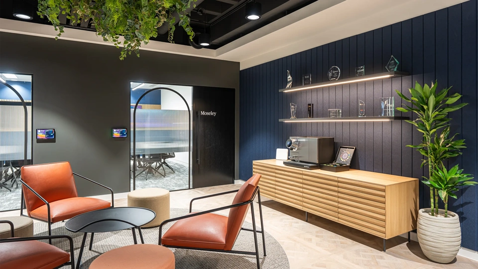 Turner & Townsend Birmingham plant based office with orange chairs and blue and grey interior
