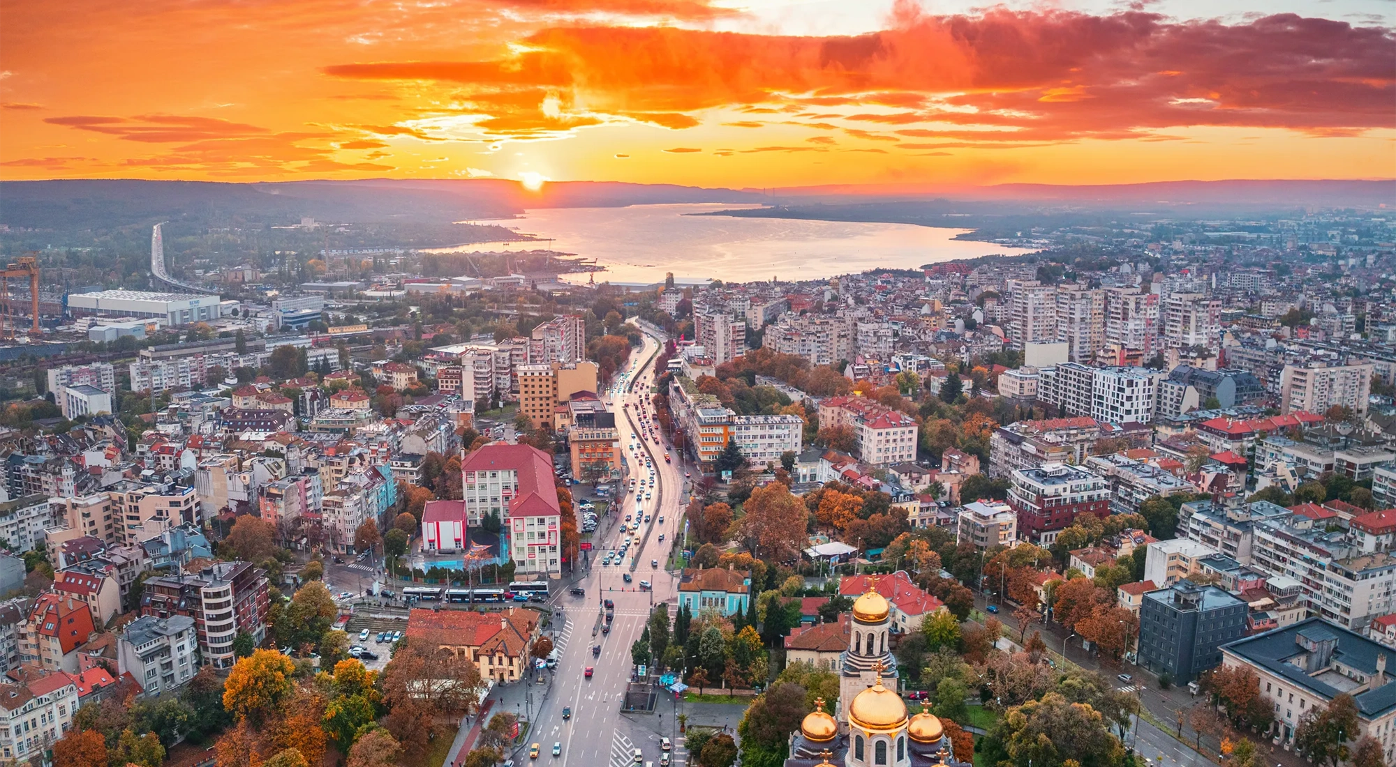 Aerial sunset panoramic autumn view of Varna city center, Bulgaria. The Cathedral of the Assumption, Asparuhovo bridge and Varna sea lake