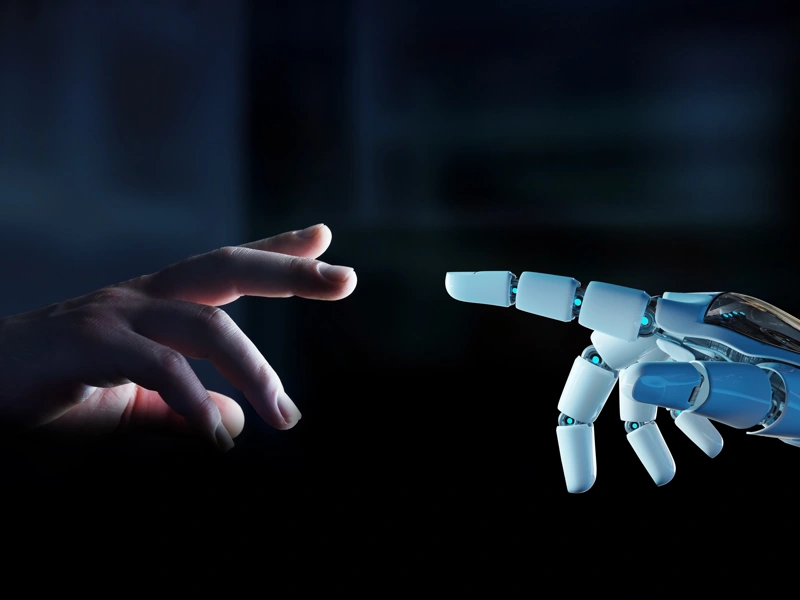 Human hand reaching out to robotic hand