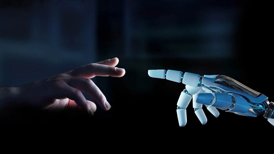 Human hand reaching out to robotic hand