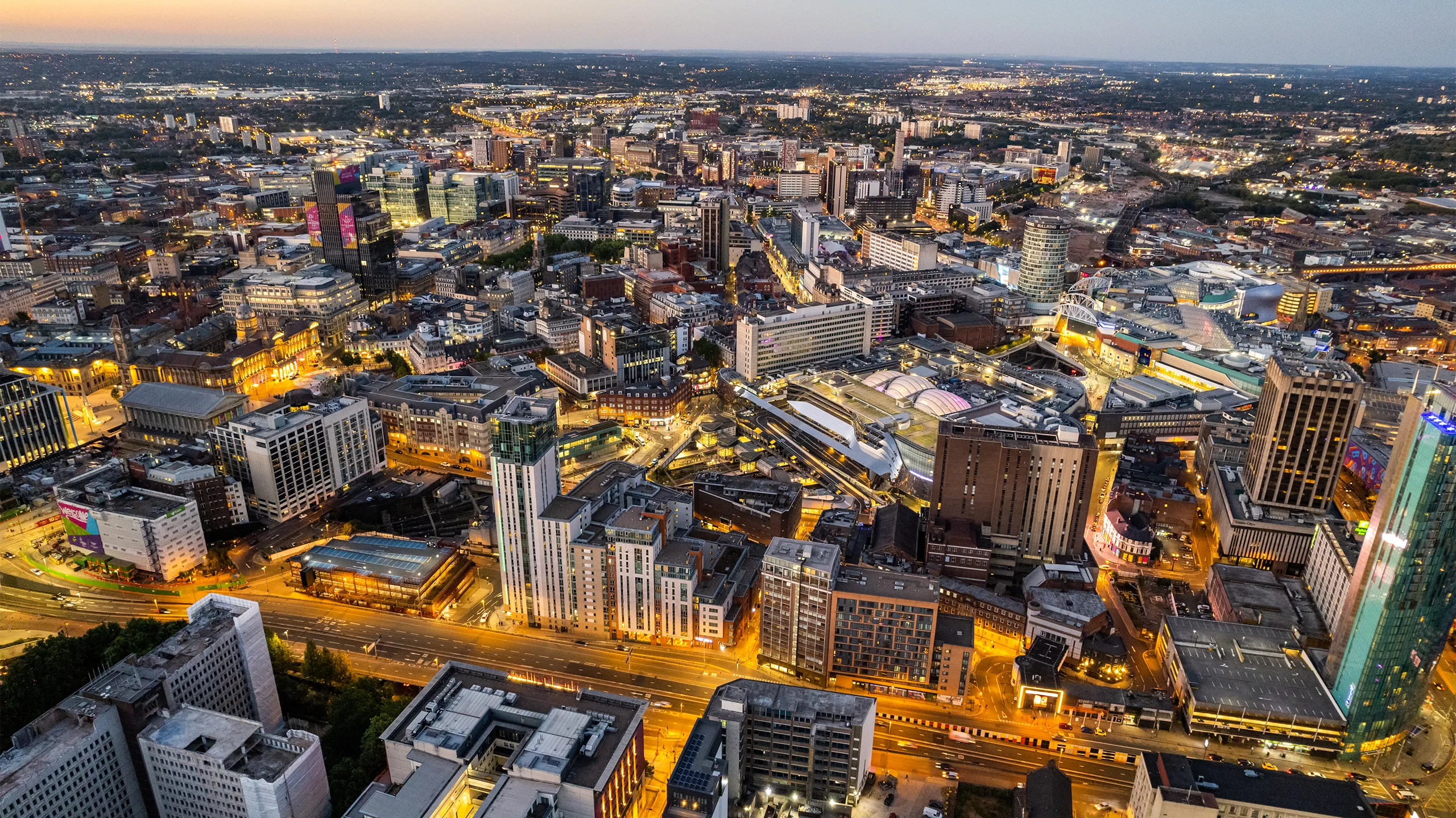 Aerial view over the city center by night including central train station