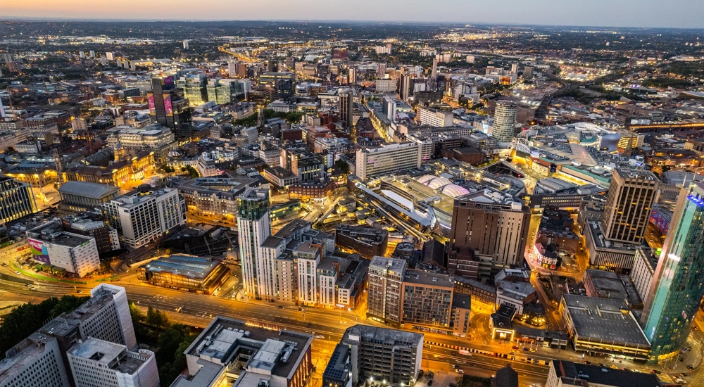Aerial view over the city center by night including central train station