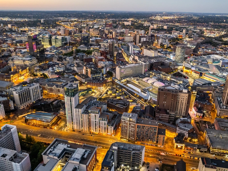 Aerial view over the city center by night including central train station