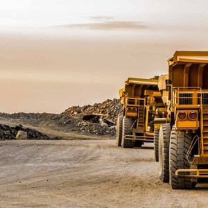 Large-mining-rock-dump-trucks-transporting-Platinum-ore-for-processing.jpg
