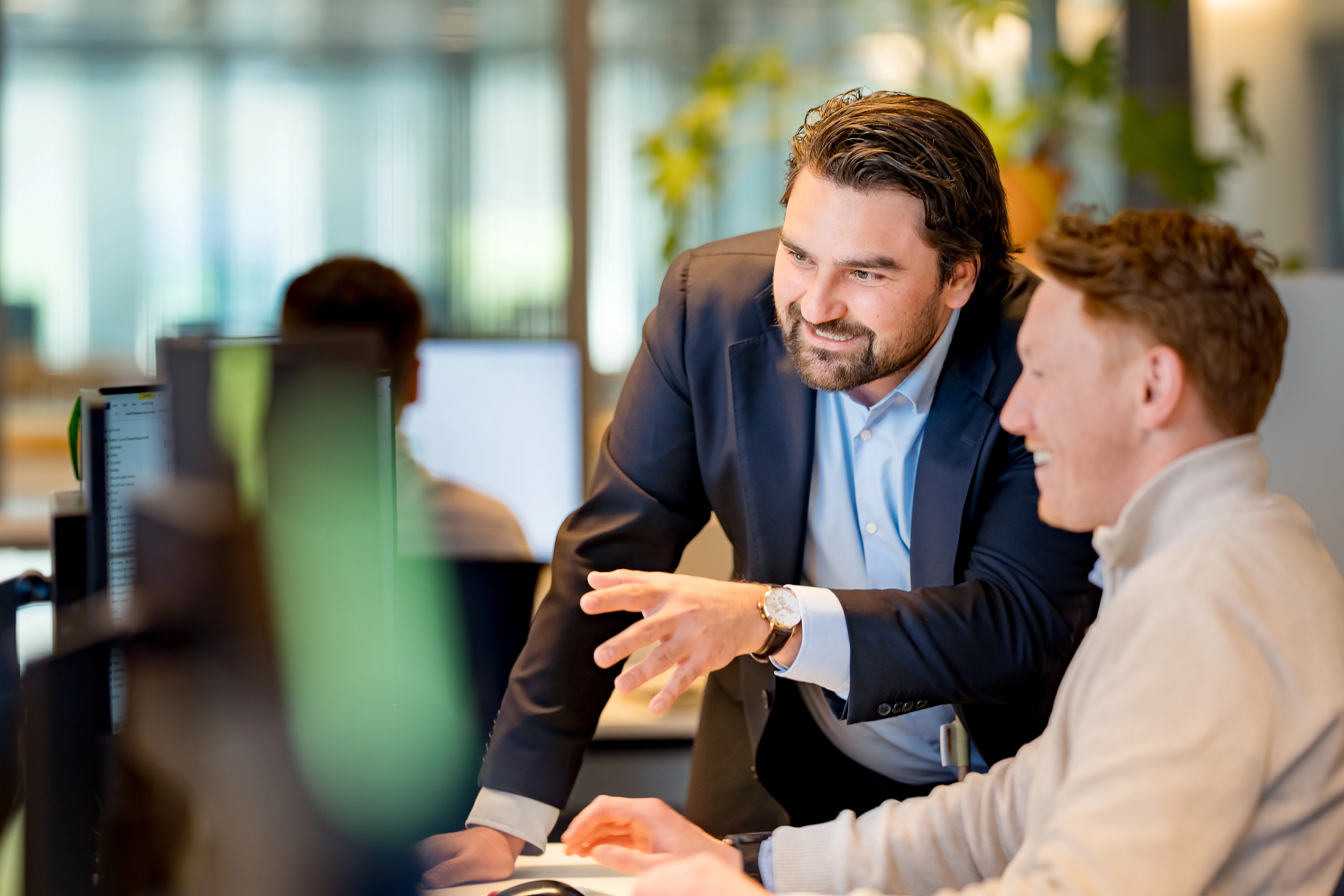 Employees in an office looking at the computer