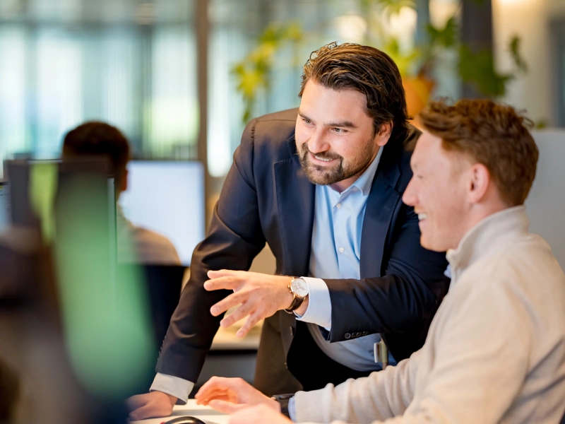 Employees in an office looking at the computer