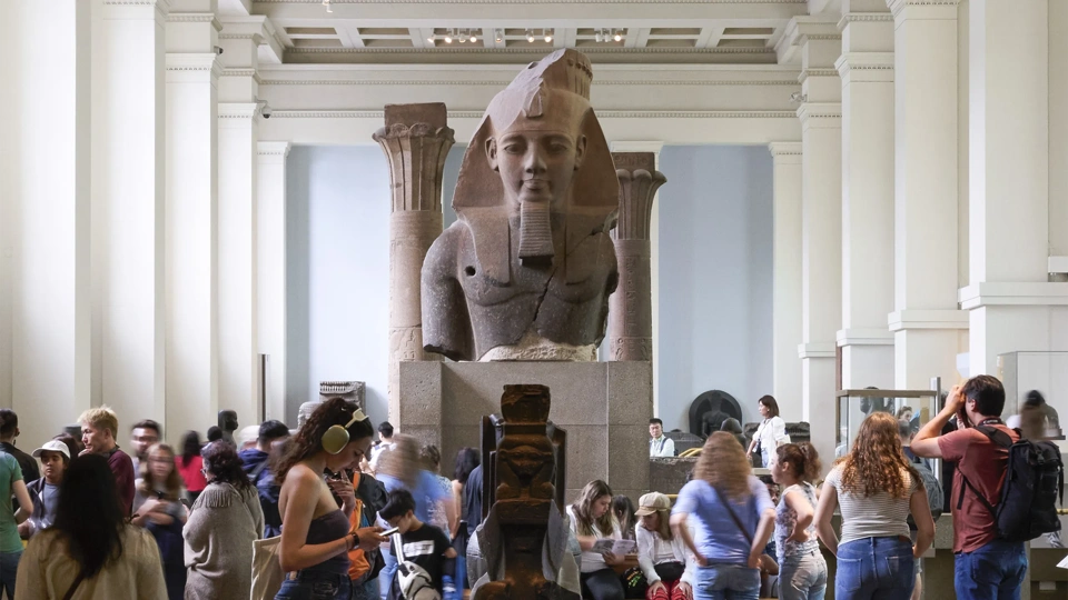 Egyptian Sculpture Gallery at the British Museum with a croud of people around it