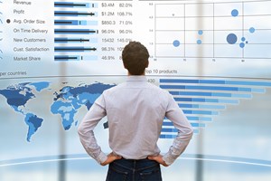 Man in front of a analytics dashboard