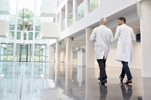 Hospital entrance with two doctors in lab coats 