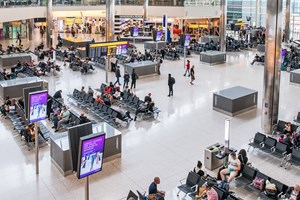 Interior of Heathrow Airport's departures, with shops and people 