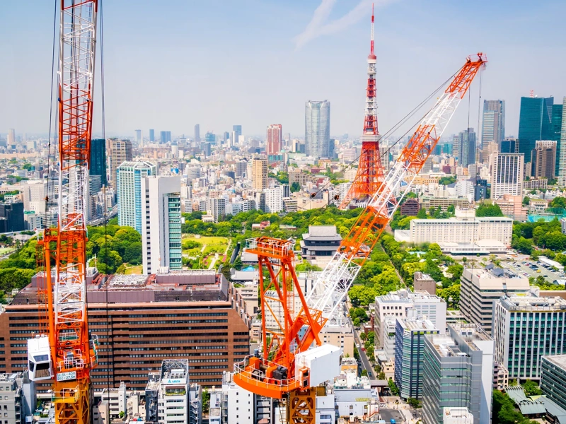 Aerial view of cranes in a construction site in downtown Tokyo.