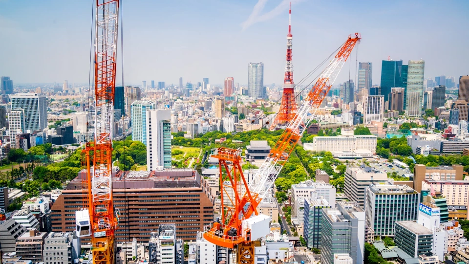 Aerial view of cranes in a construction site in downtown Tokyo.