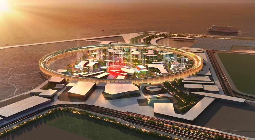 Ariel rendering of the Osaka Expo pavilion, Japan at sunset, showing a circular central structure surrounded by modern buildings and pathways within a large exhibition site.