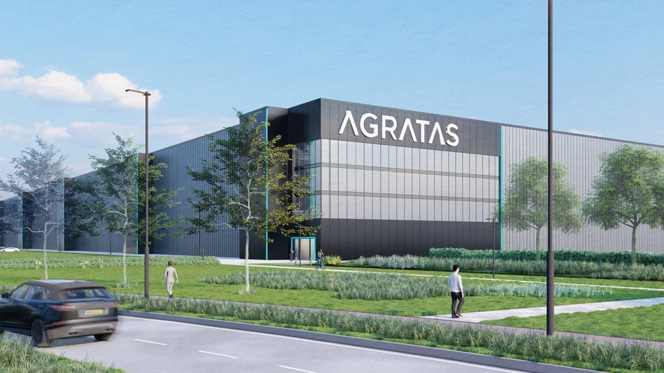 Render image of a battery plant with surrounding landscaping