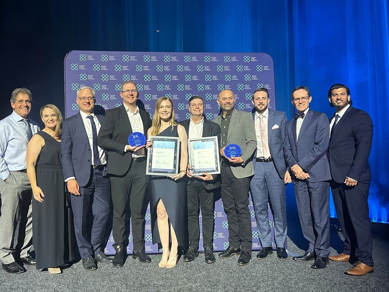 Group shot of award winners with awards