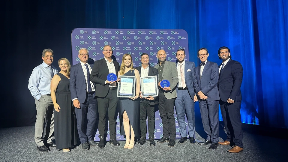 Group shot of award winners with awards