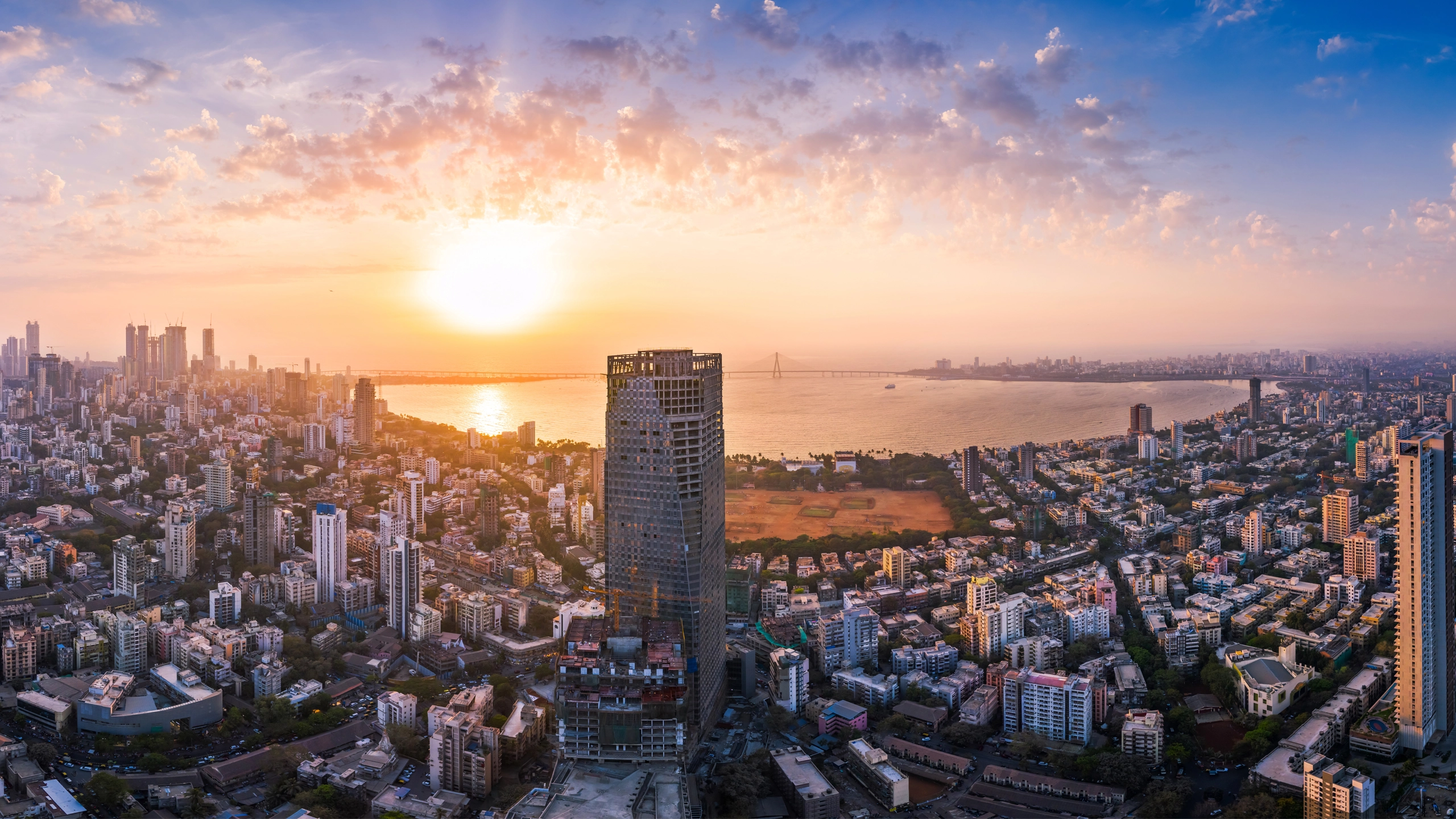 The Bandra Worli Sea Link is seen passing over the Mahim Bay, with the city around it. Dadar, Prabhadevi, Lower Parel, Worli, Matunga, Mahim and Bandra can be seen.