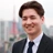 Portrait of Jin Parisien, Data Centre Services Lead, Asia, standing outside with city landscape in the background, smiling.