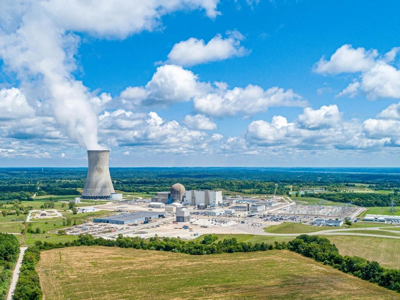 coal fired power station with cooling towers releasing steam into atmosphere
