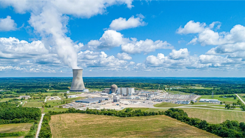 coal fired power station with cooling towers releasing steam into atmosphere