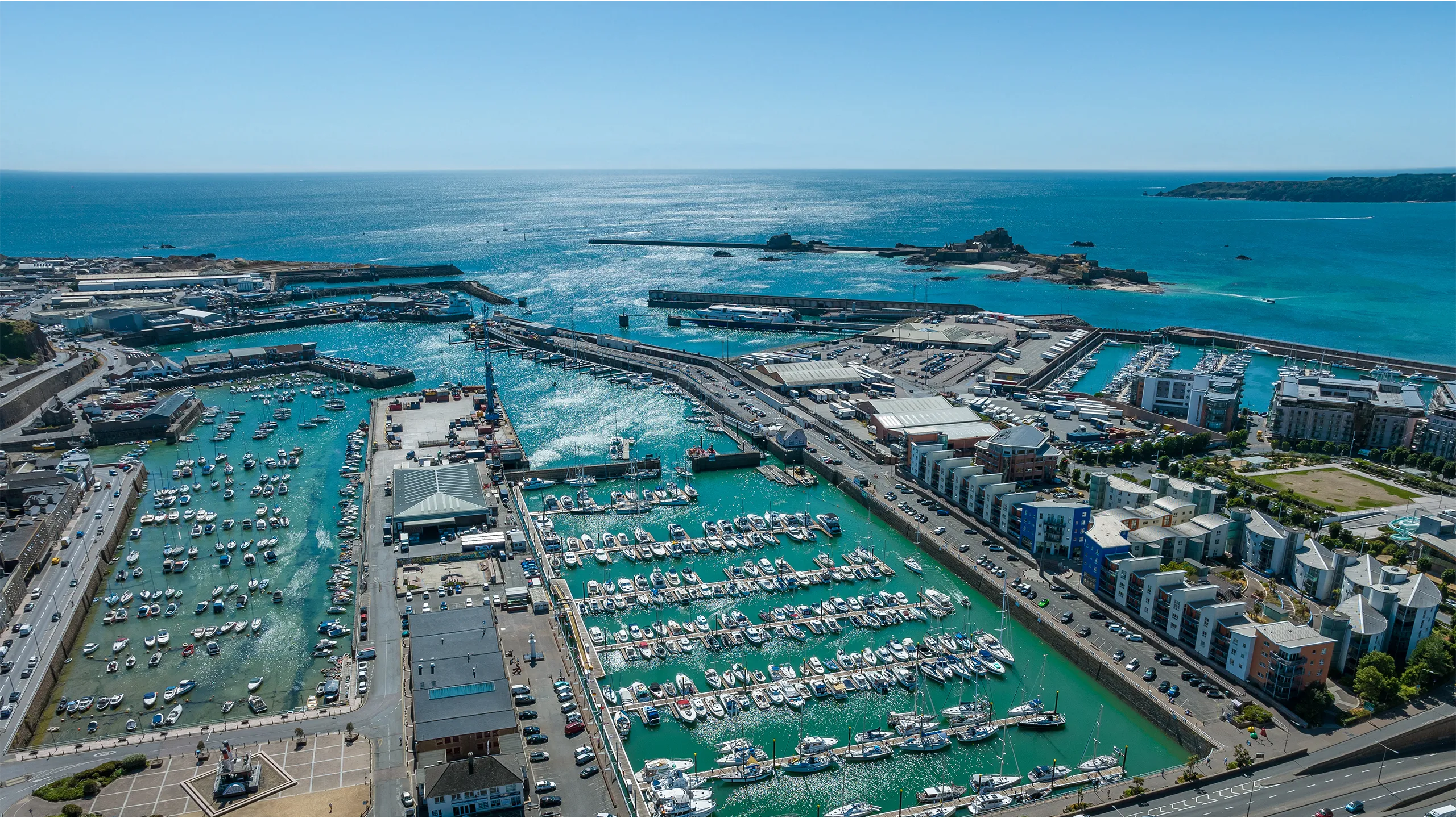 Jersey Harbours aerial with clear blue water and sky in the distance